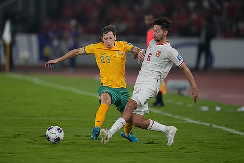 2026 FIFA World Cup Qualifying, Indonesia Australia: Indonesia's Sandy Walsh, right, battles for the ball against Australia's Craig Goodwin 